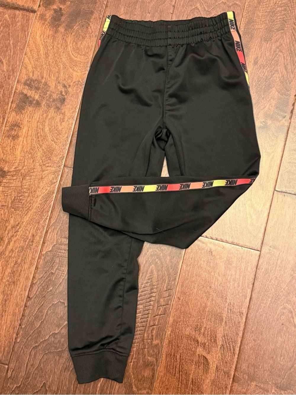 Nike Kids Black Joggers with Red, Yellow, Orange Logo Tape